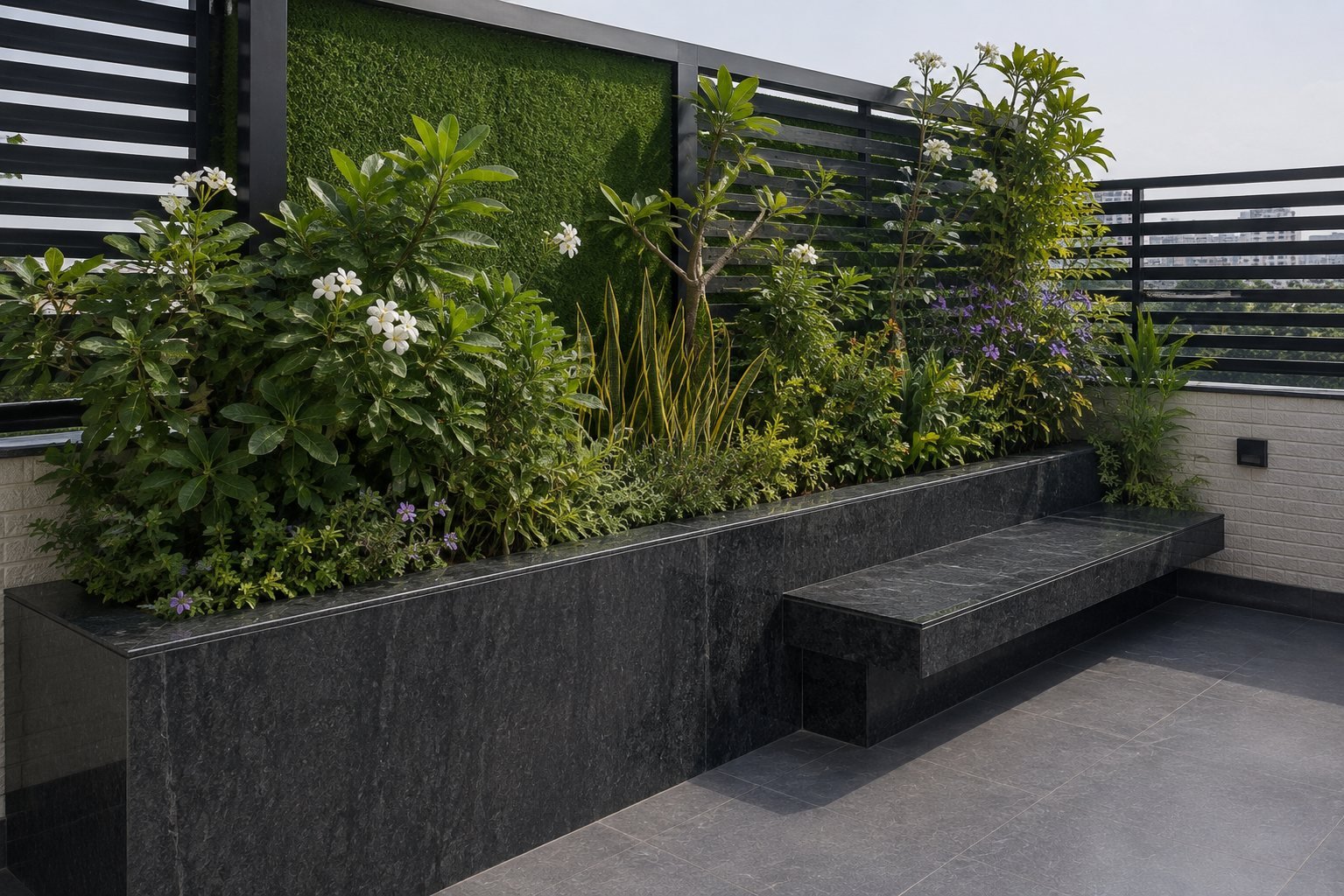 The planted corner of the terrace and its stone bench